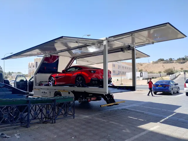 A supercar loaded into an enclosed transporter